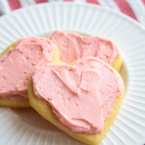 close up of valentine sugar cookies frosted with pink frosting