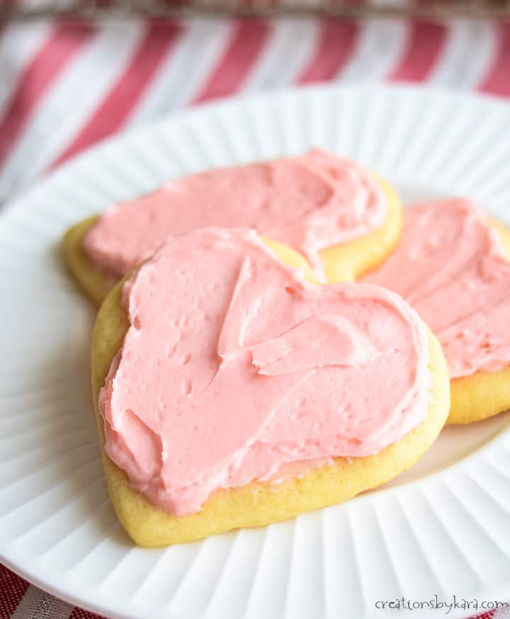 plate of heart shaped sugar cookies with pink frosting