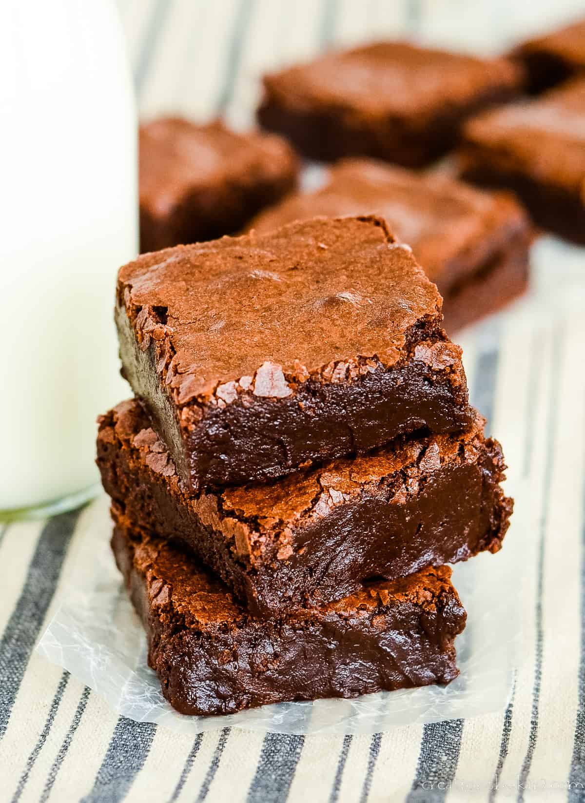 overhead shot of stack of cocoa brownies with milk in the background
