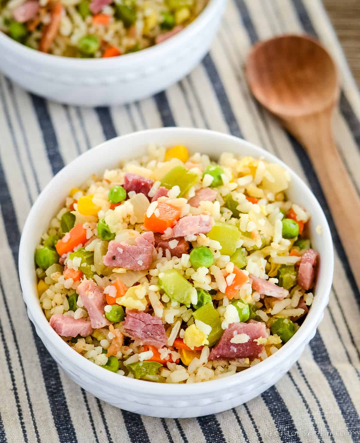 overhead shot of bowl of fried rice with ham and vegetables