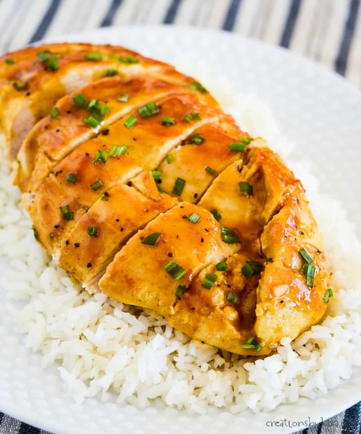 honey mustard baked chicken on a plate with white rice