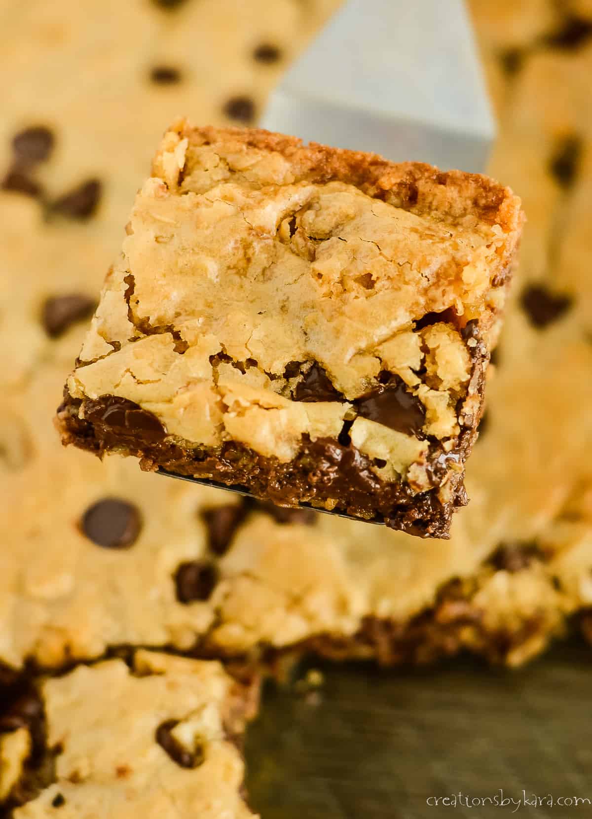 oatmeal chocolate chip bar being lifted out of a pan with a spatula