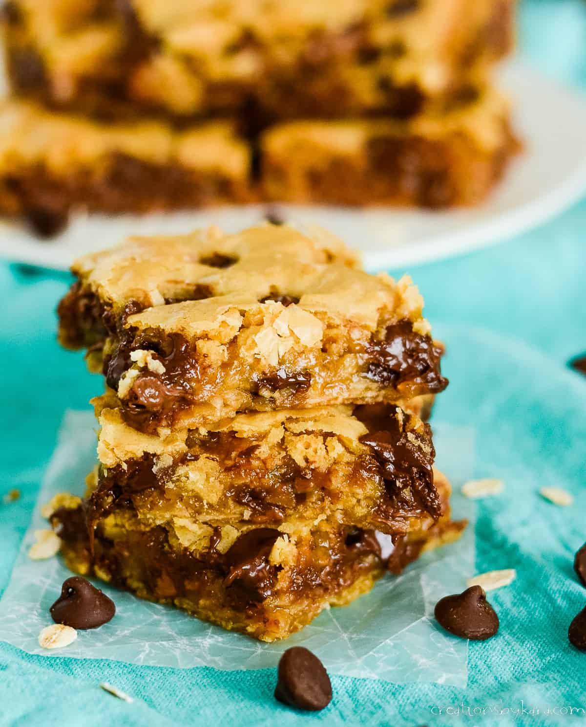 stack of ooey gooey oatmeal cookie bars with chocolate chips