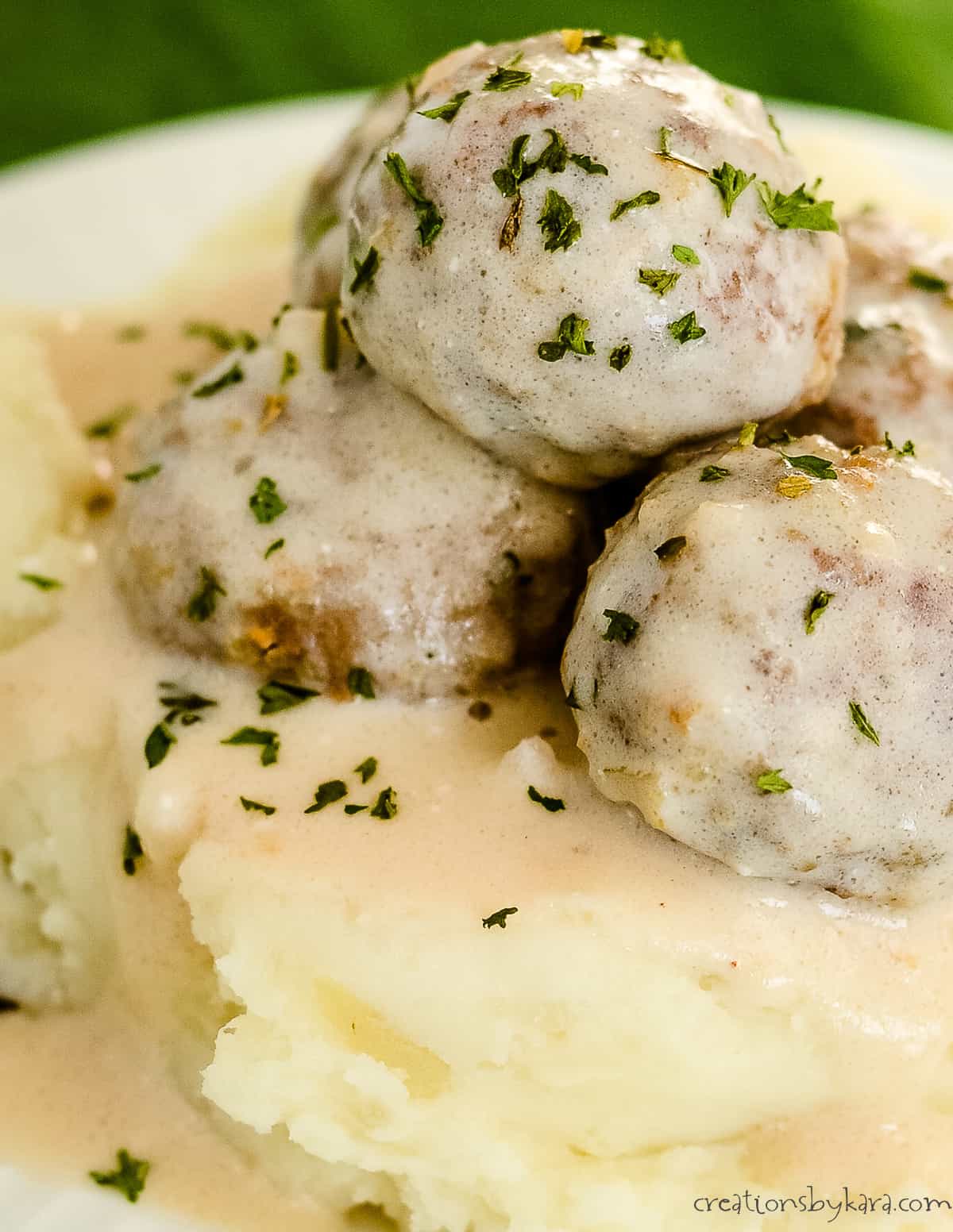 close up of swedish meatball gravy with sour cream