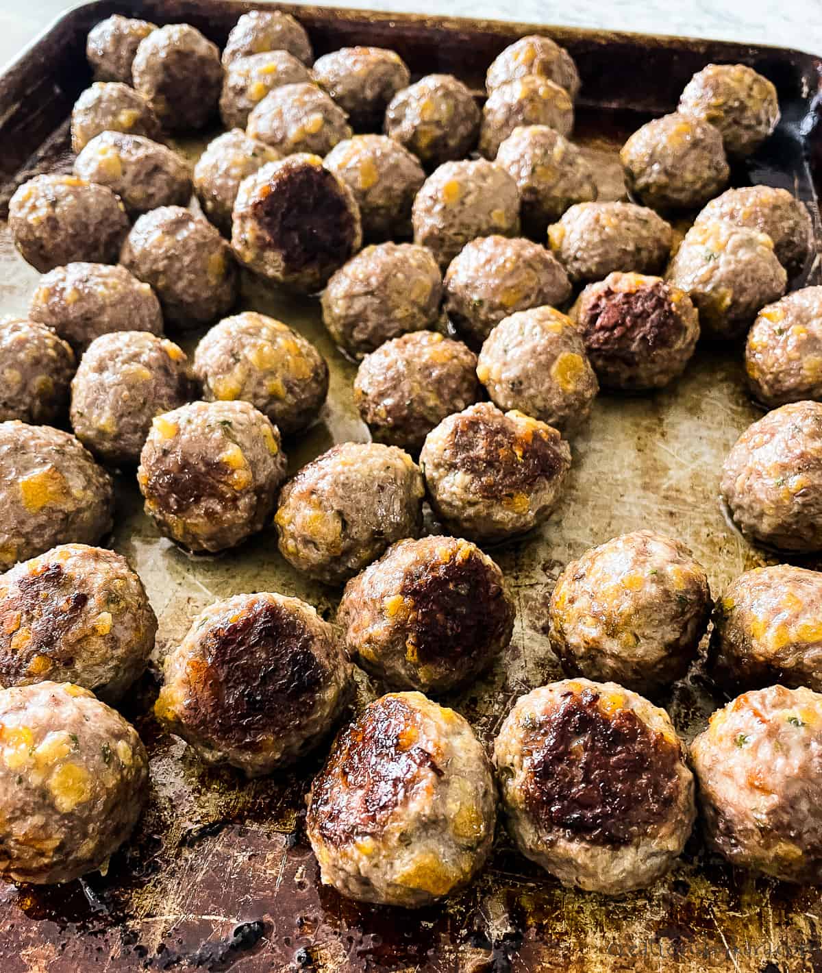 baked meatballs on a cookie sheet