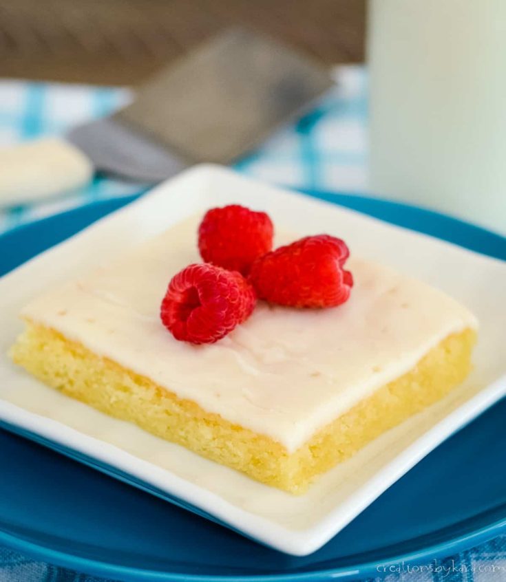texas white sheet cake recipe, on a plate topped with raspberries