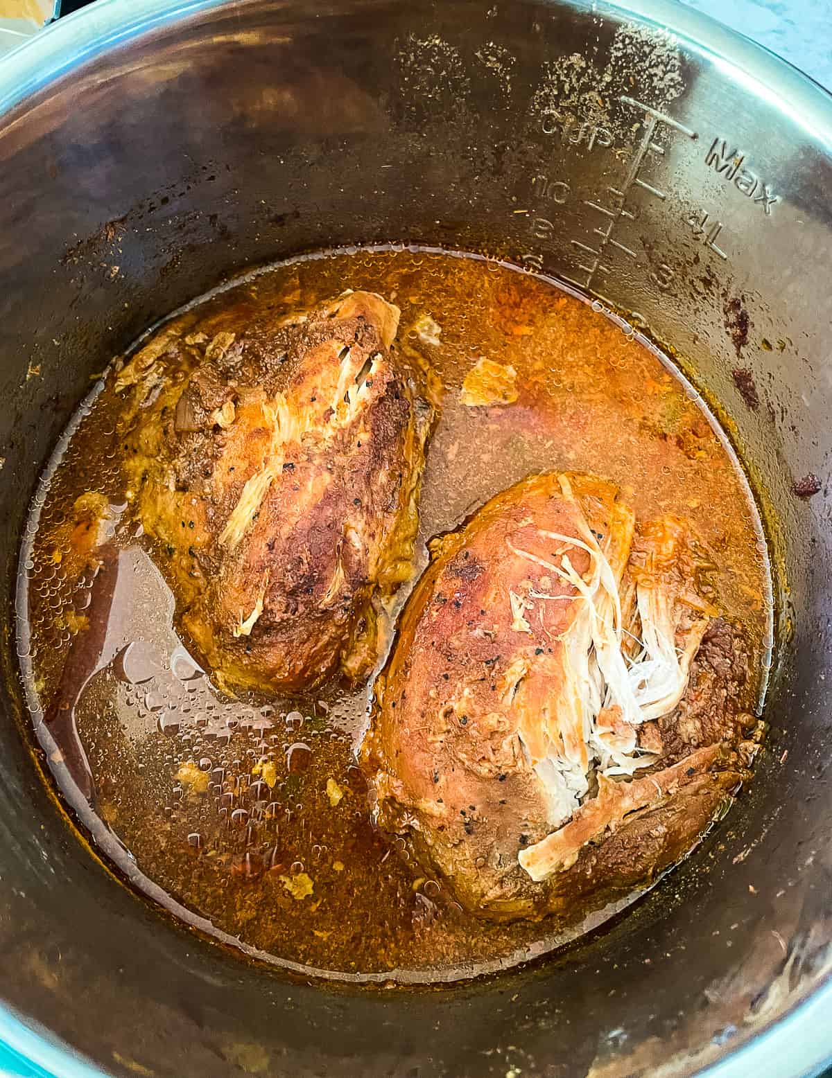 pot of cooked pork that needs to be shredded