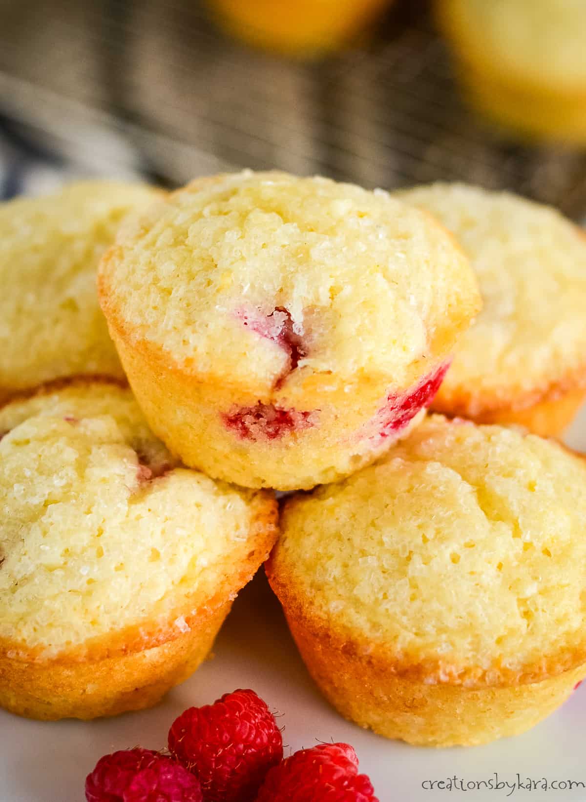 stack of lemon raspberry muffins on a white cake stand