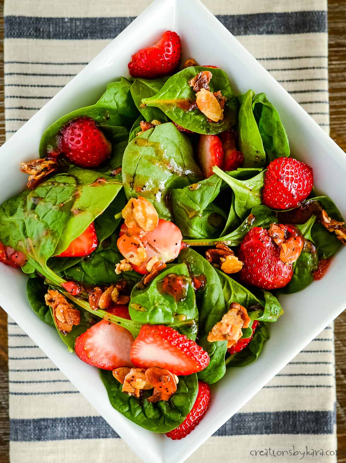 bowl of spinach strawberry salad with strawberry dressing