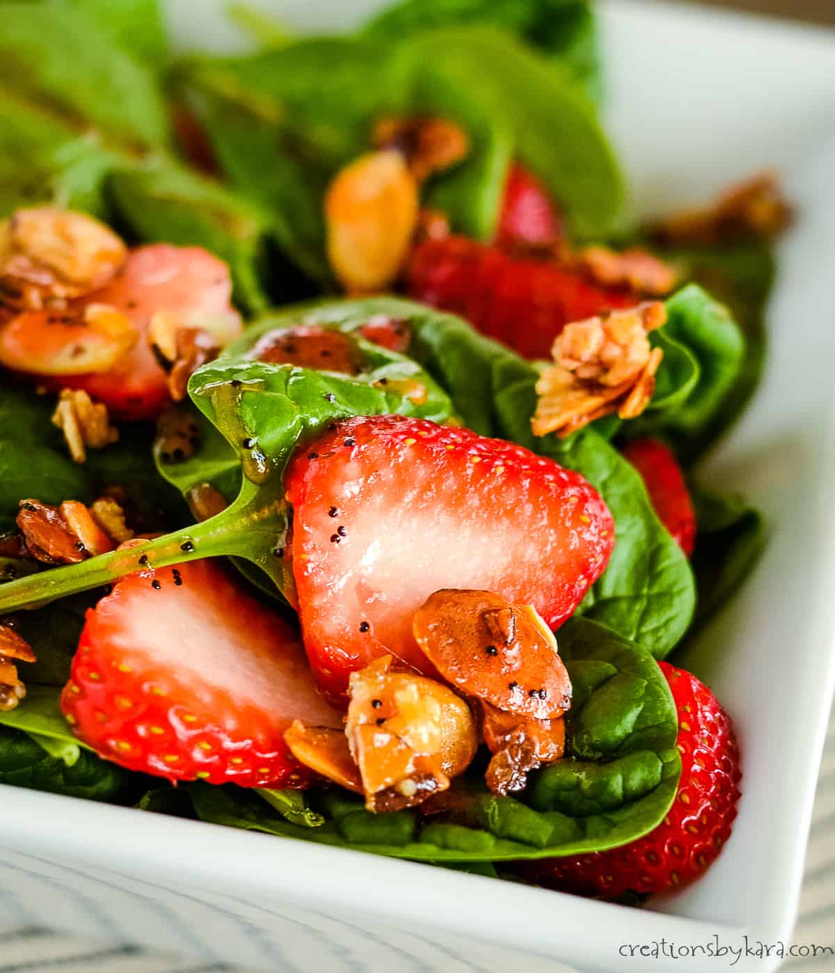 close up of salad with spinach and strawberries