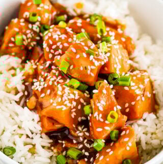 honey garlic chicken sauce over chicken and rice in a bowl