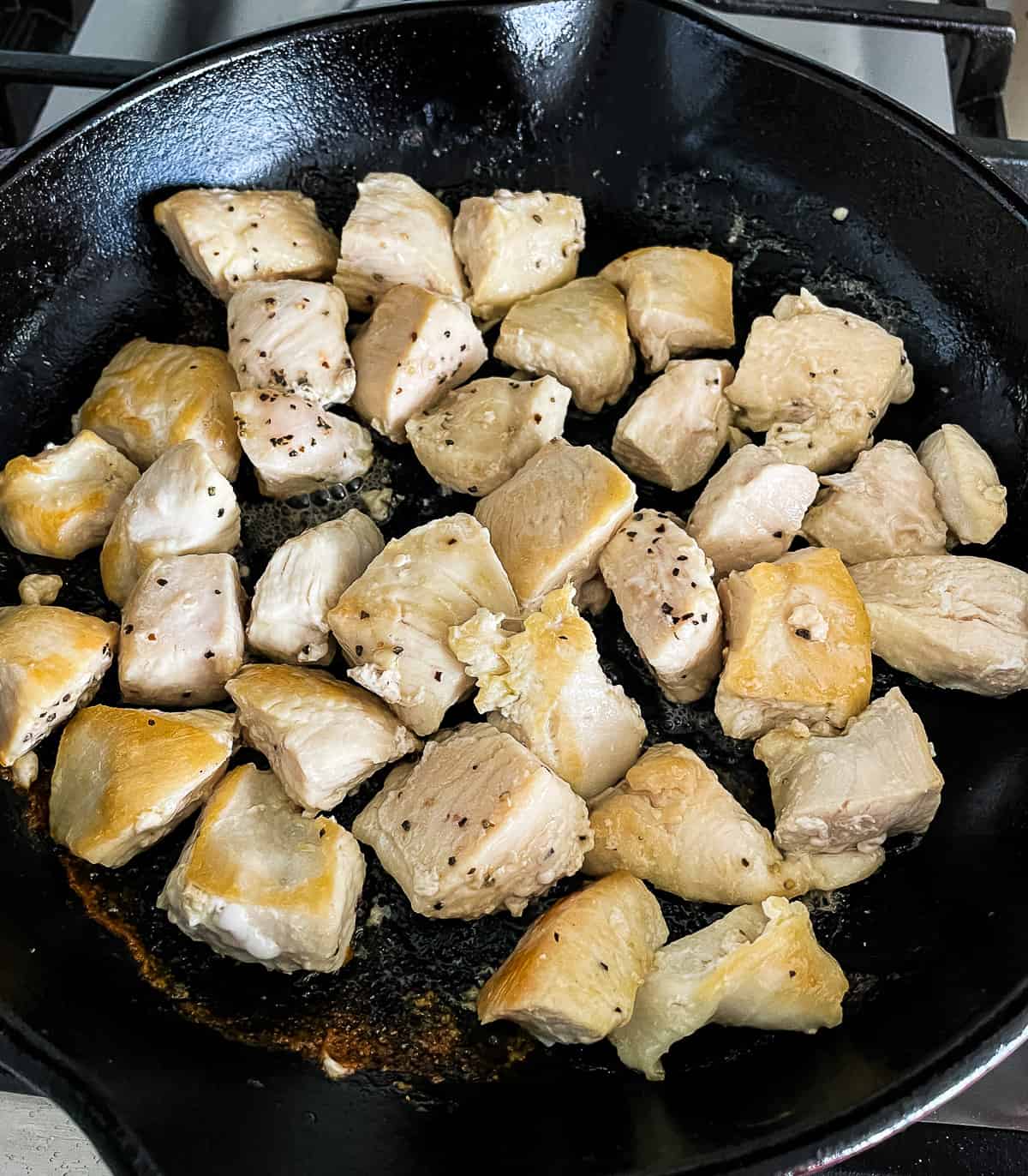 chicken chunks browning in a skillet