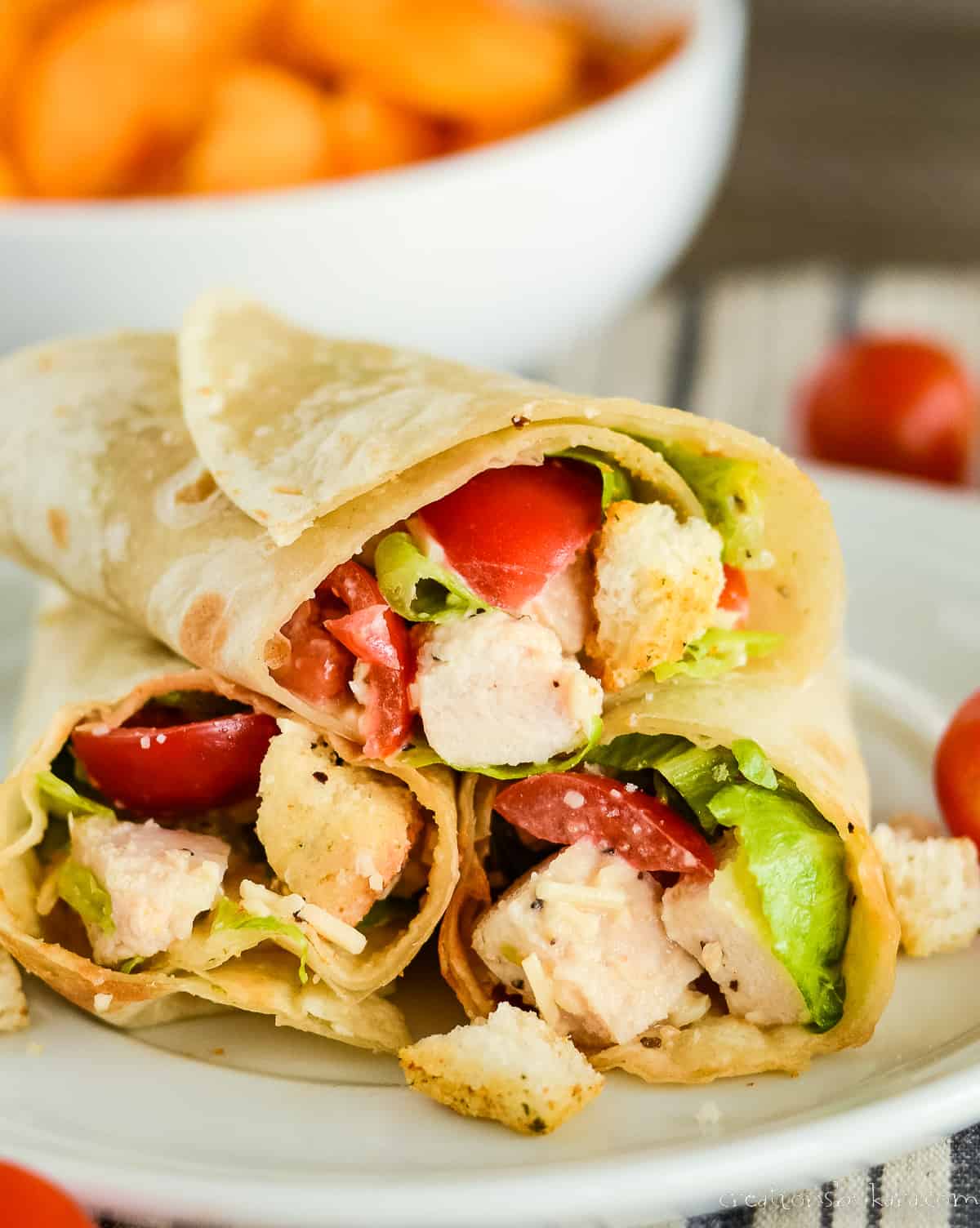 wraps with chicken, romaine, tomatoes, caesar dressing, and parmesan