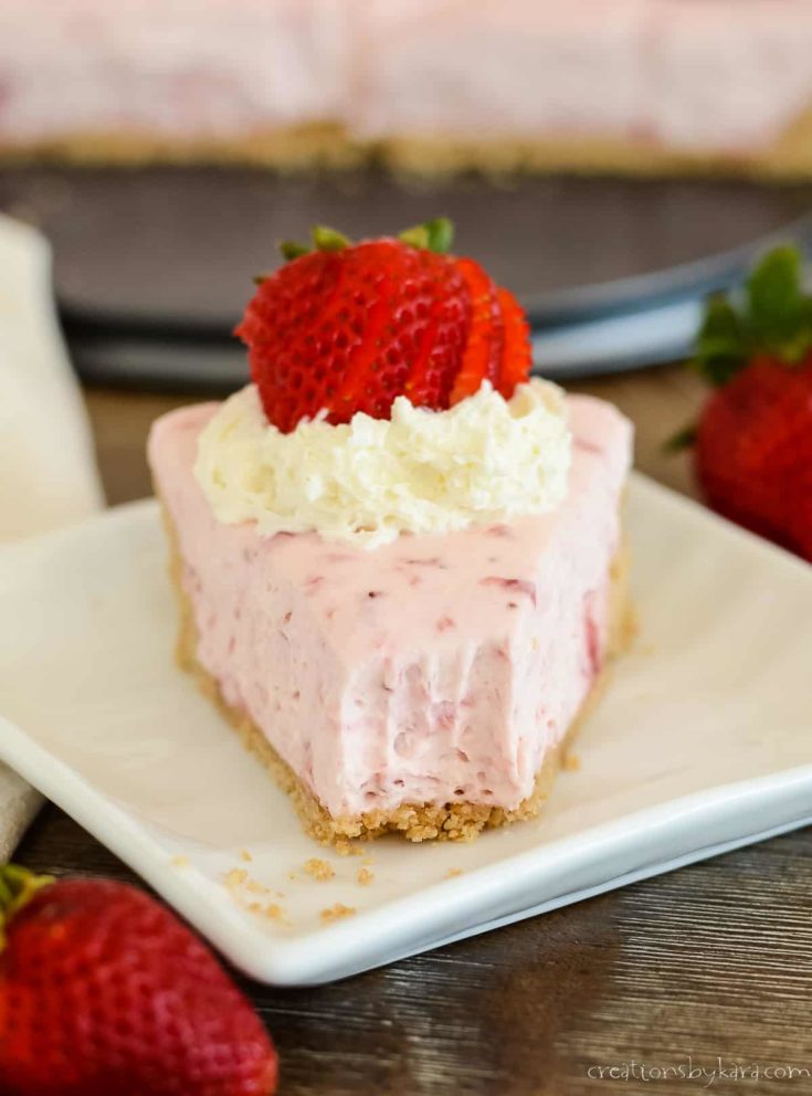 slice of no bake strawberry cheesecake with a bite taken out of it