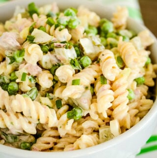bowl of macaroni salad with tuna, pickles, and peas