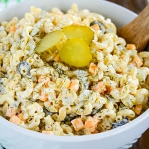 bowl of dill pickle pasta salad with slices of pickle on top