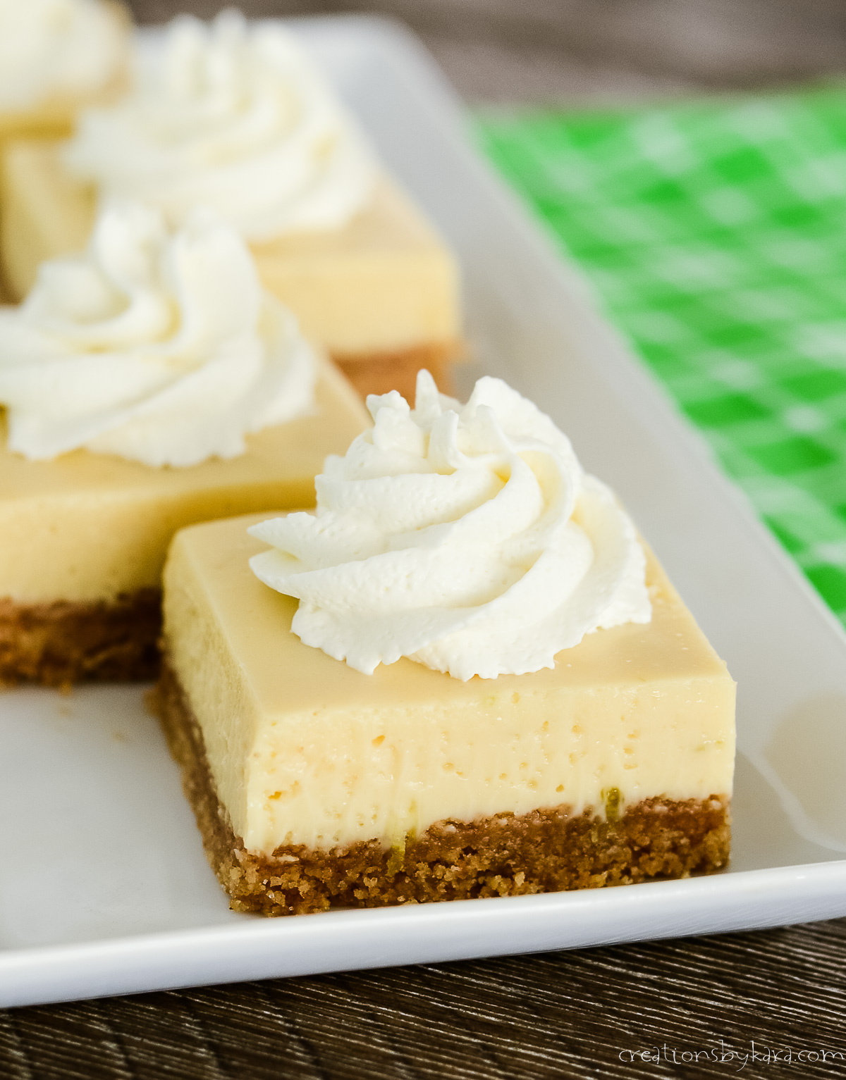 key lime pie bar topped with whipped cream