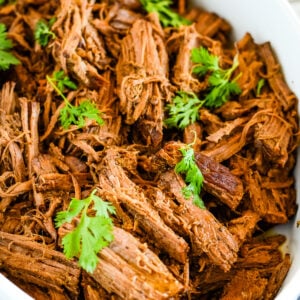 dish of shredded balsamic pot roast garnished with parsley