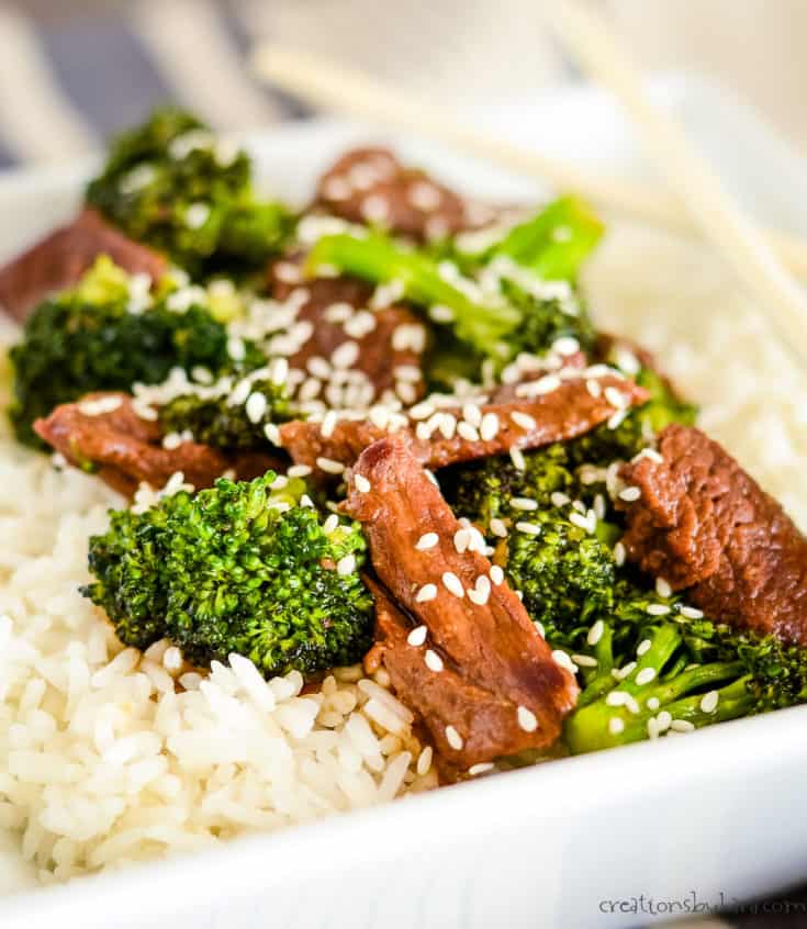 rice, broccoli, beef, and sesame seeds in a bowl