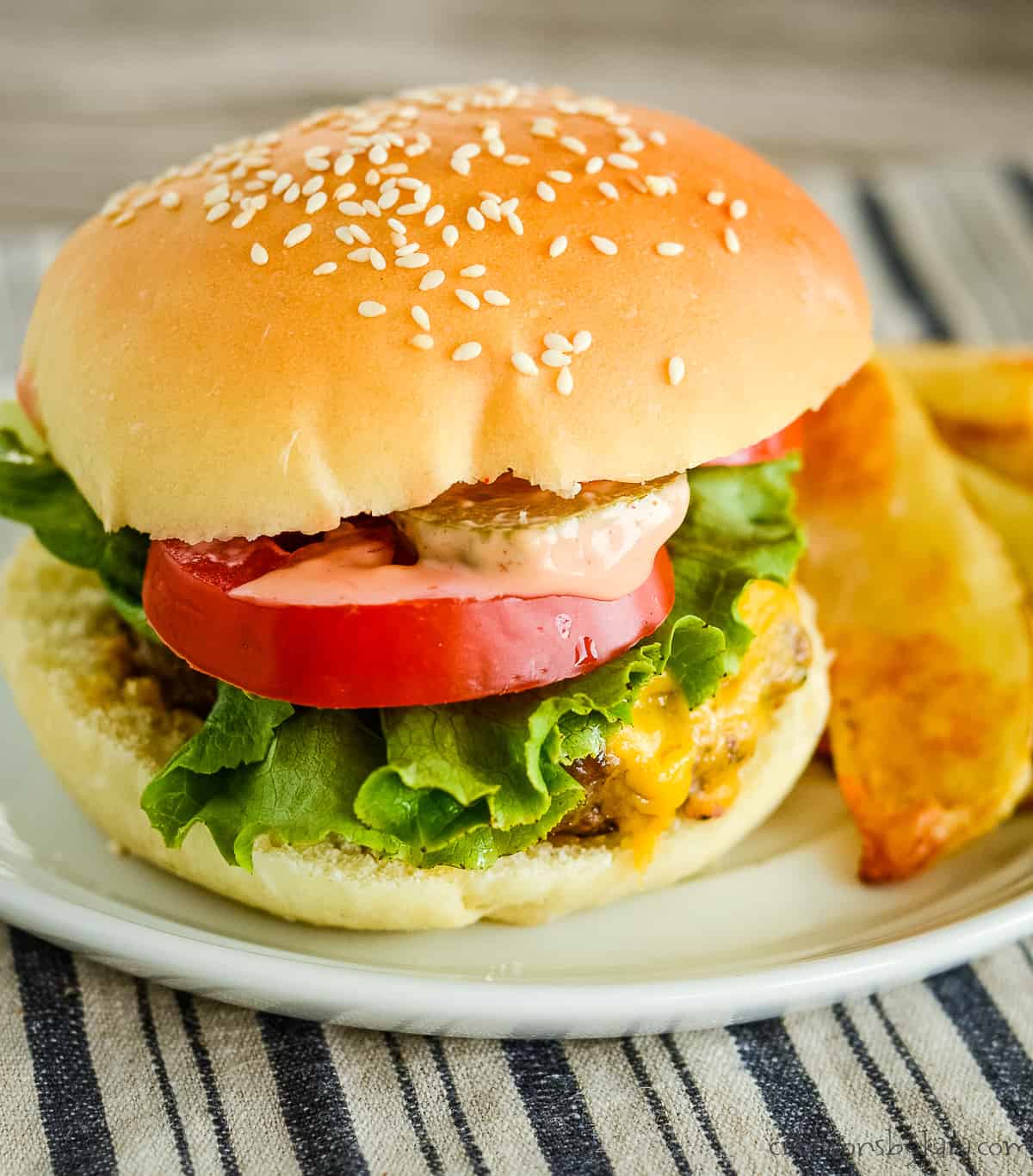 hidden valley ranch burger with cheese, lettuce, and tomato