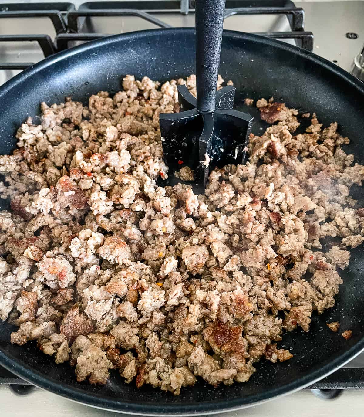 sausage browning in a skillet