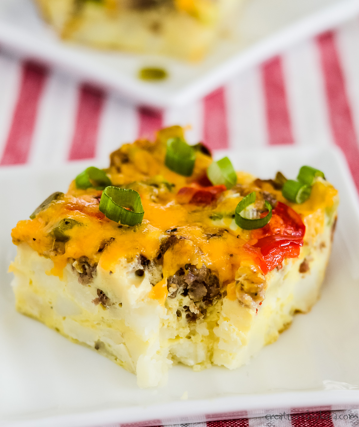 slice of sausage hashbrown breakfast casserole on a white plate