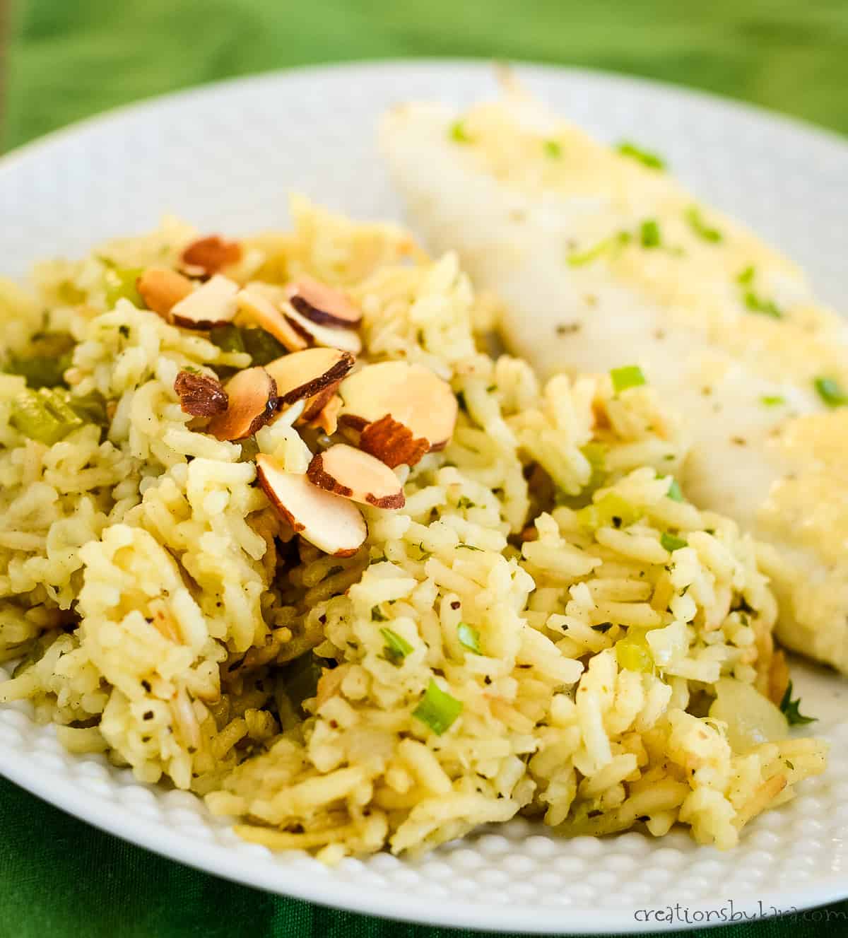 plate of tilapia and almond pilaf rice