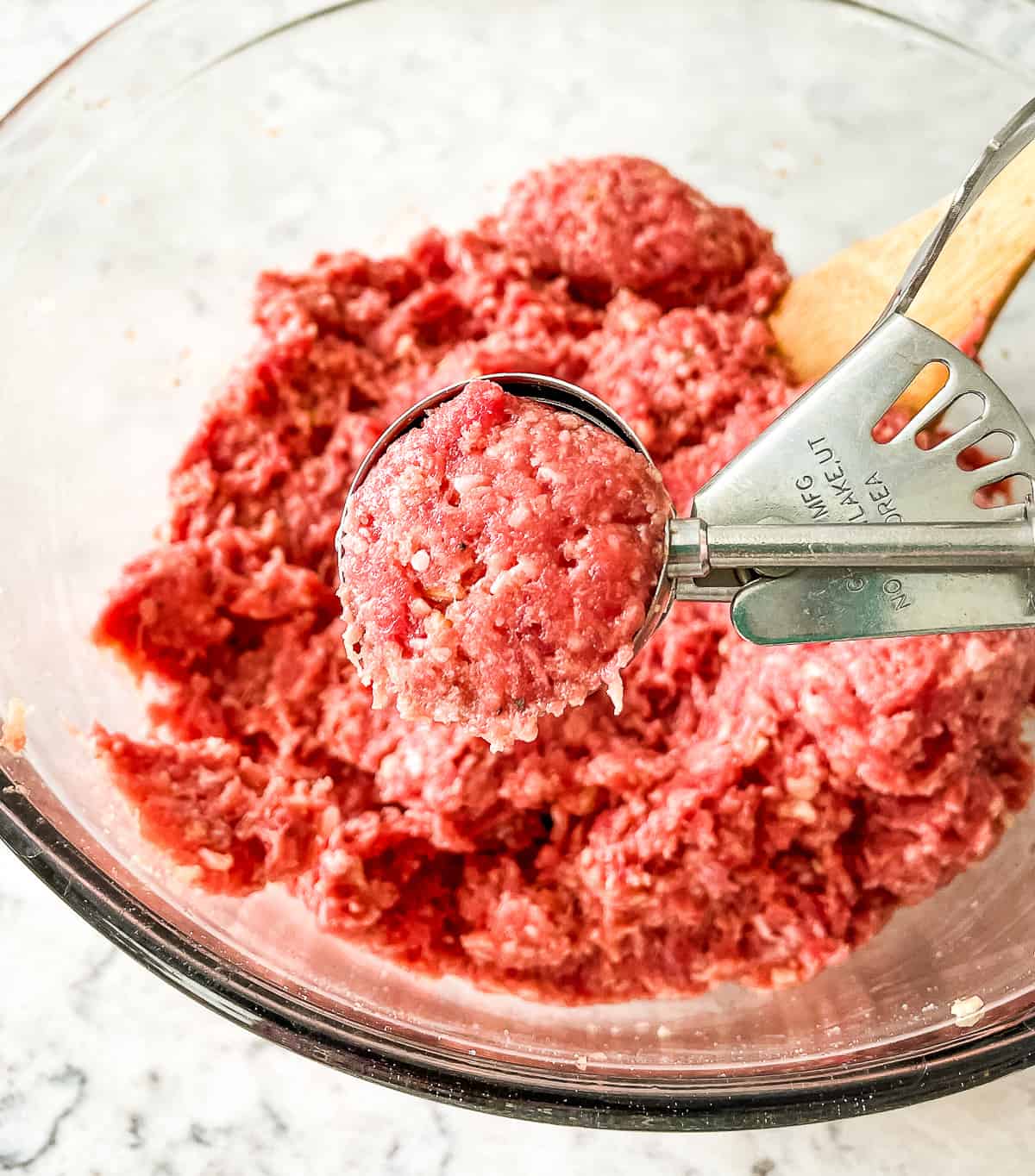 using a cookie scoop to form meatballs