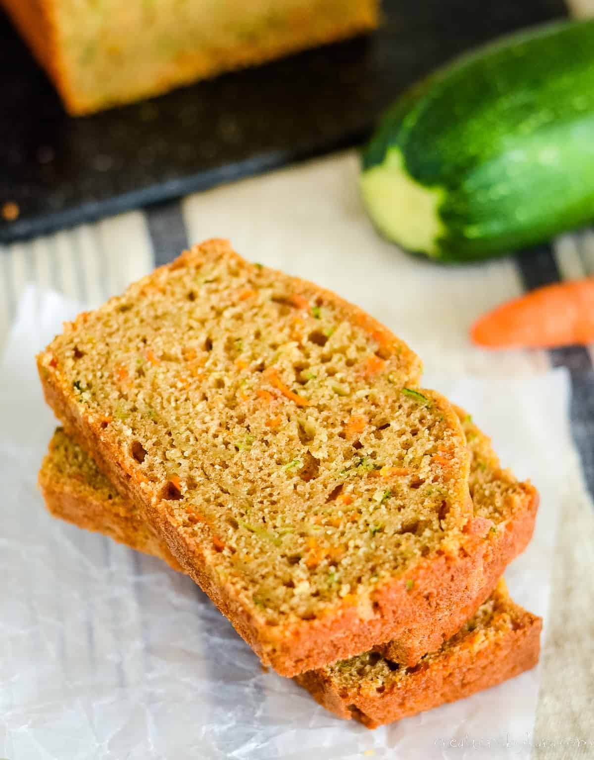 overhead shot of stack of slices of zucchini carrot bread