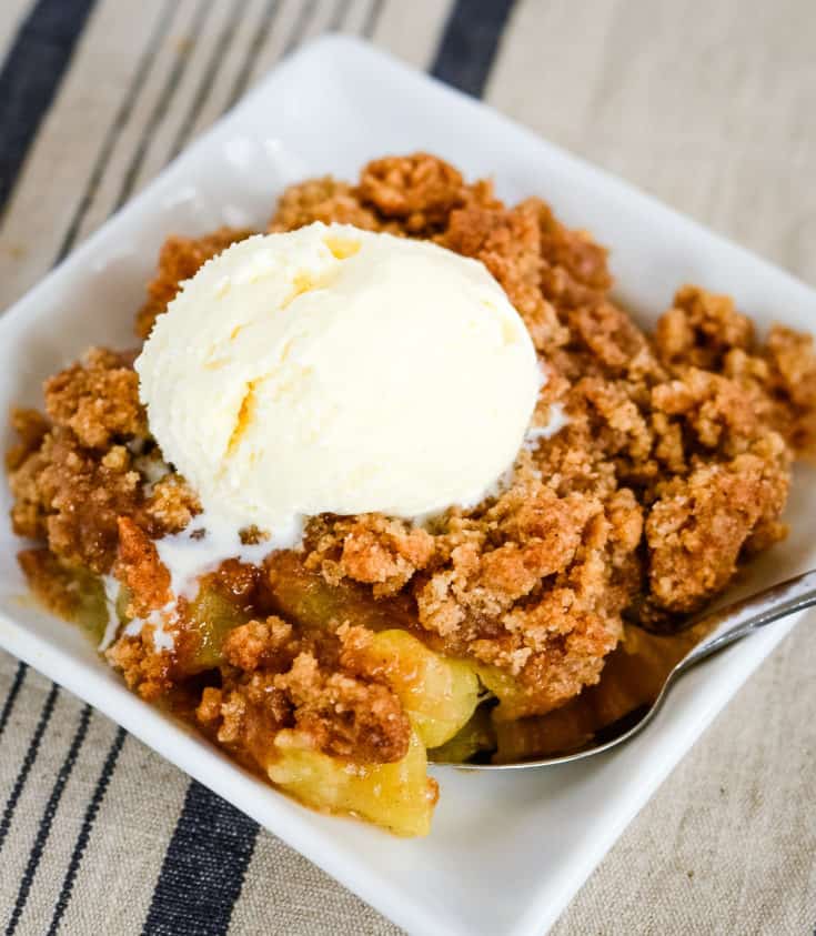 brown apple betty with a scoop of vanilla ice cream