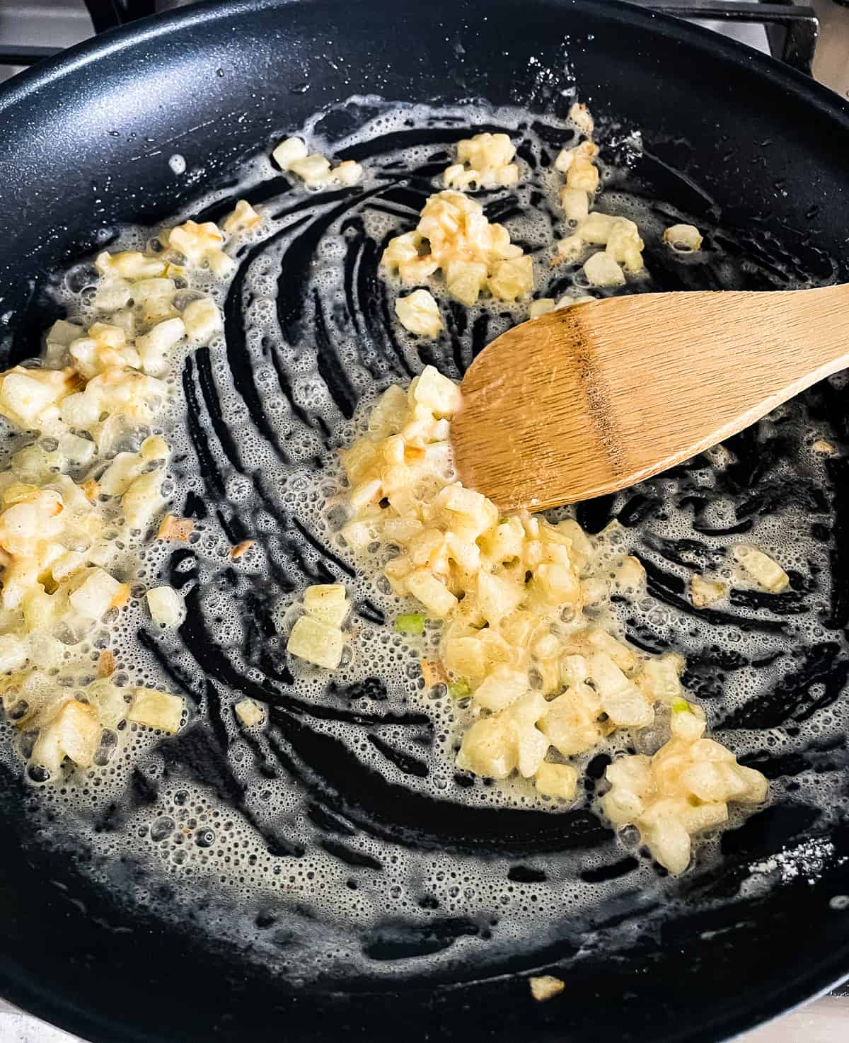 making a roux with butter, flour, and onions