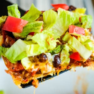 close up of crescent roll taco bake with lettuce and tomato