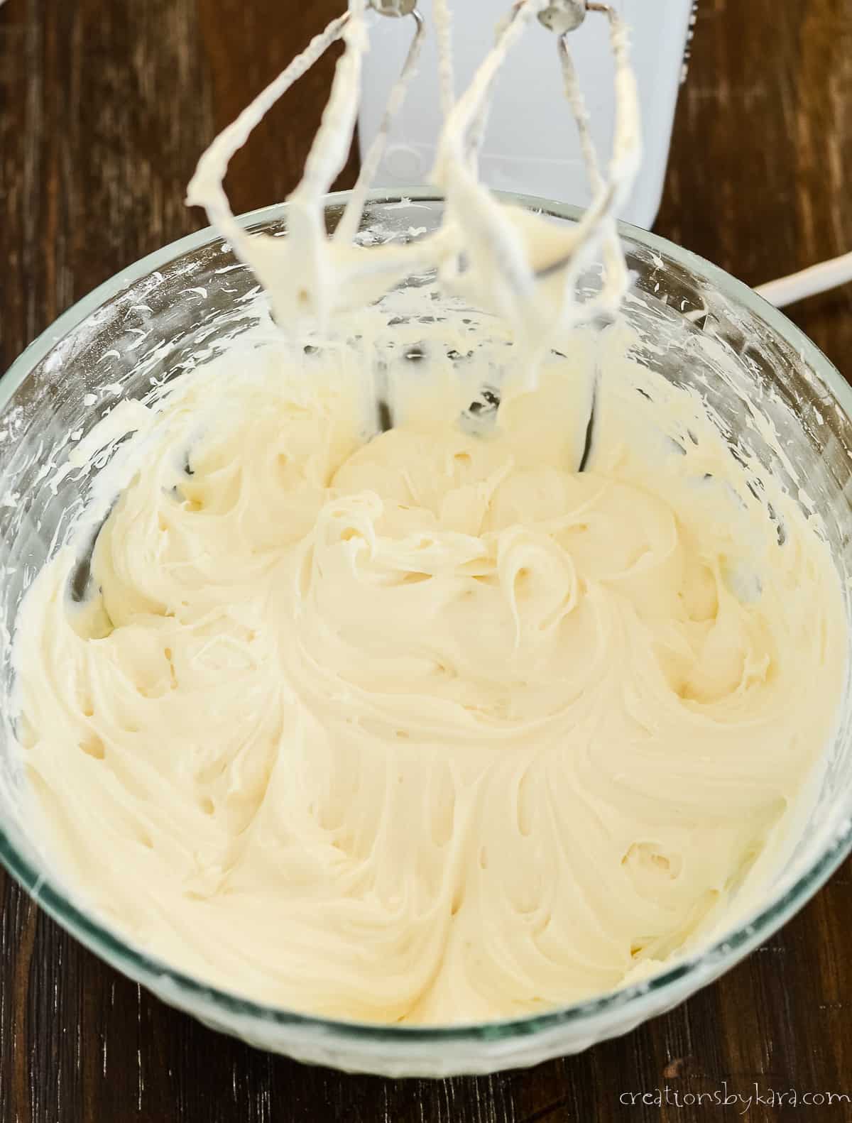bowl of frosting and a mixer
