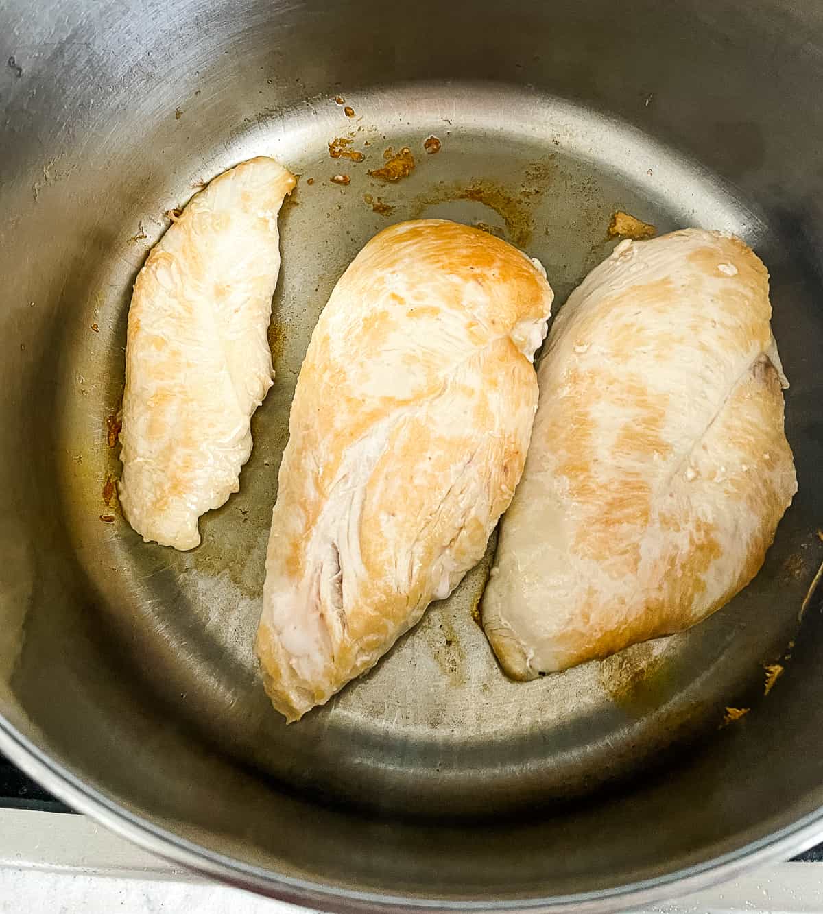 chicken browning in a pot