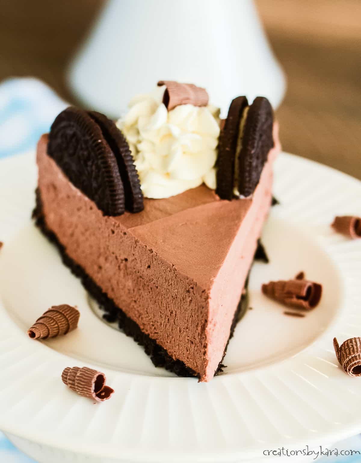 slice of chocolate mousse cake on a plate with chocolate curls