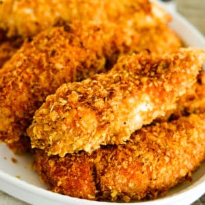 cornflake chicken tenders on a white serving tray