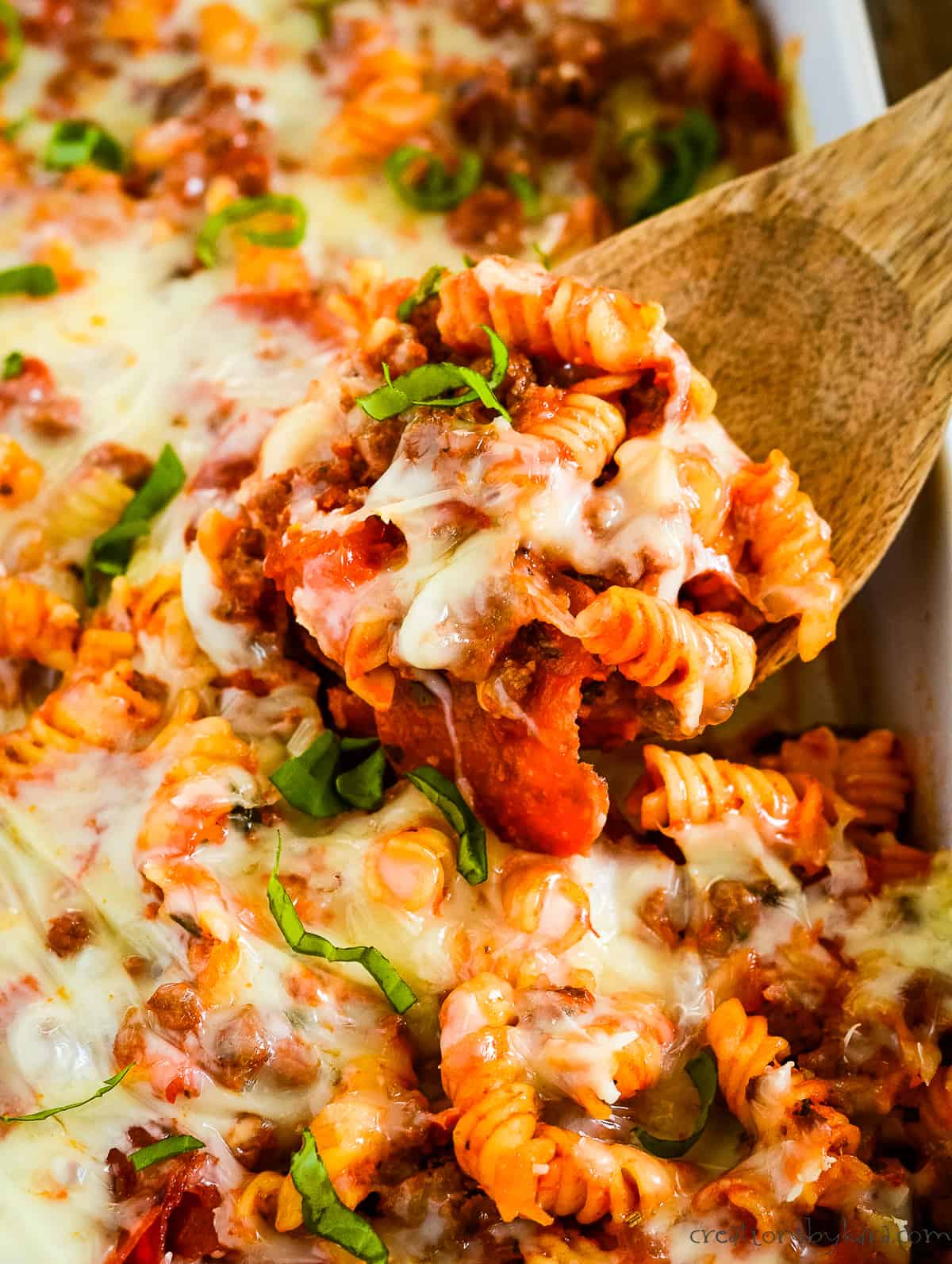 scoop of pizza casserole with pepperoni and cheese