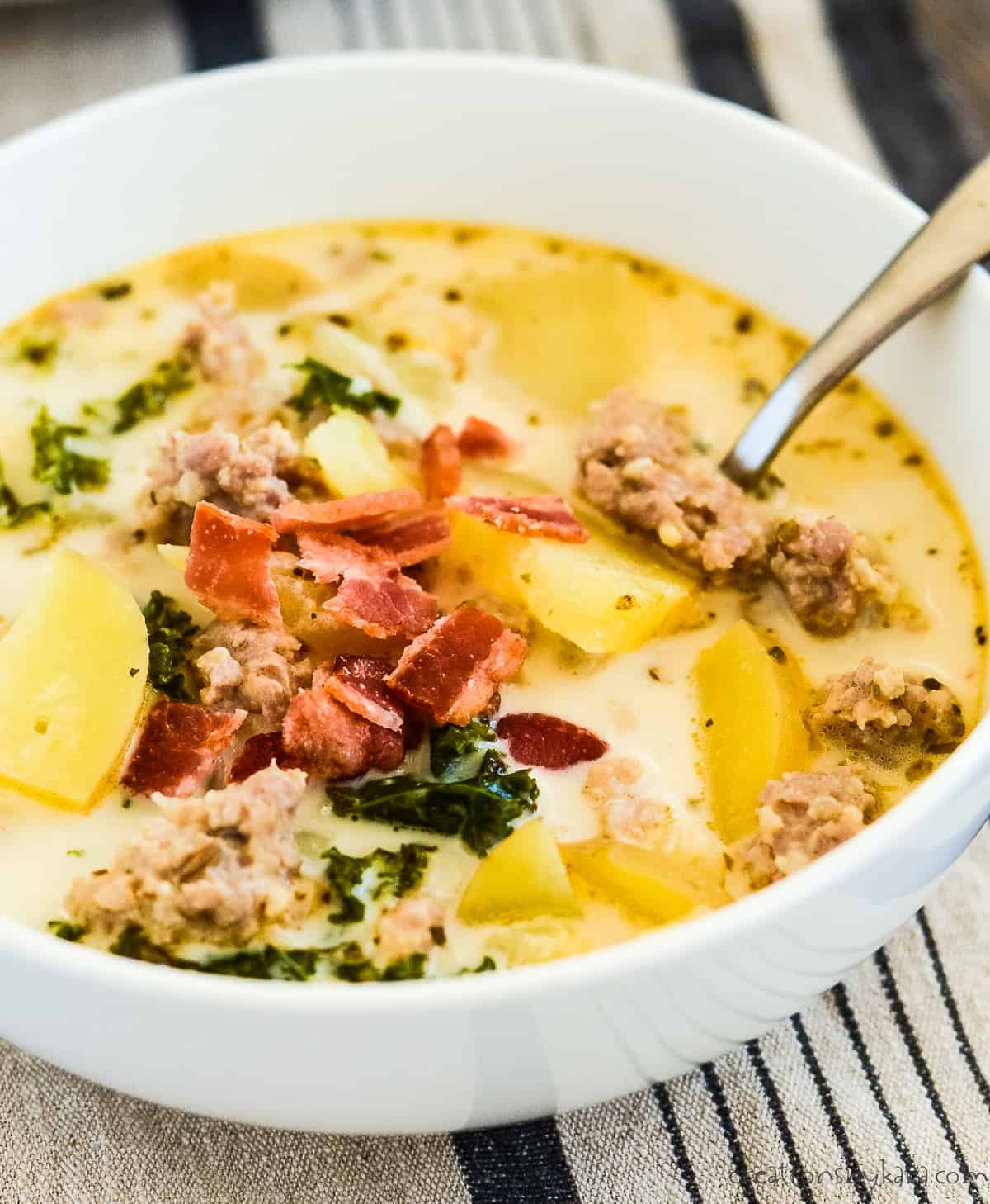 bowl of one pot zuppa toscana soup with bacon bits