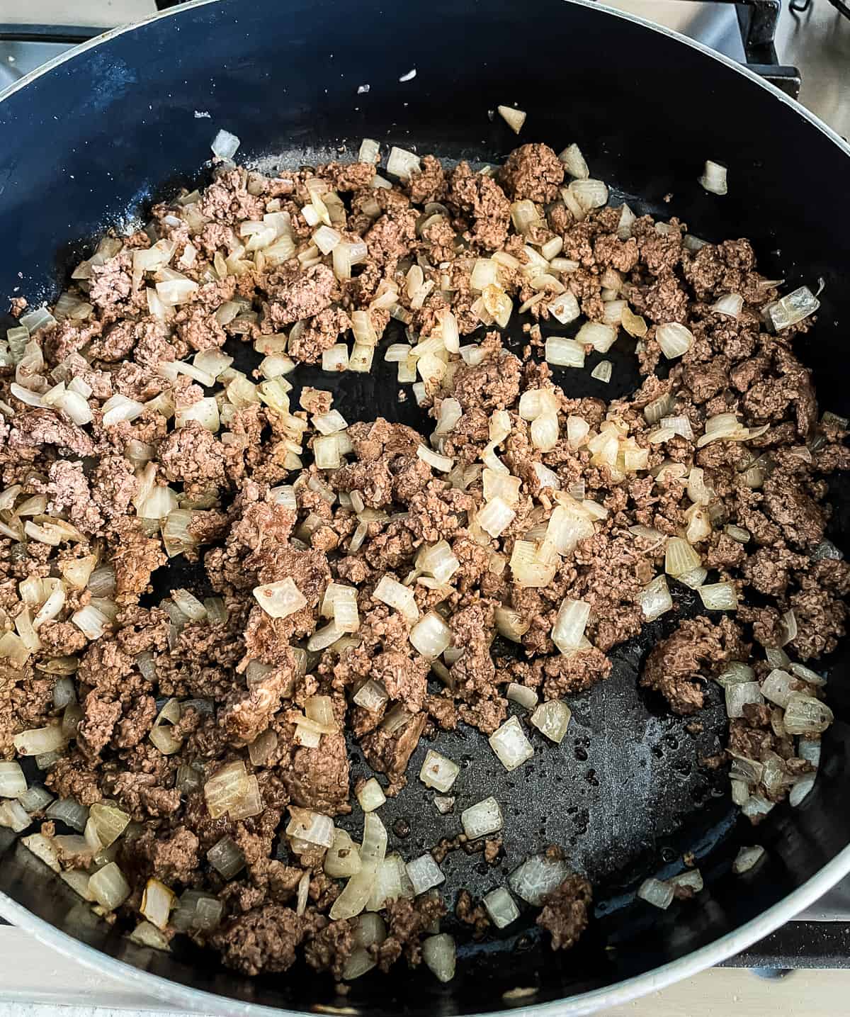 browned beef and onion in a skillet