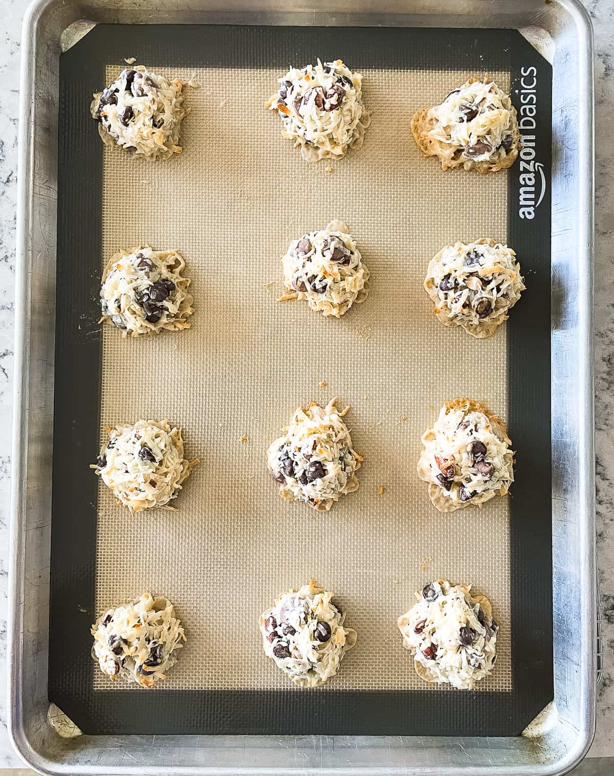 baked almond joy cookies on a silicone lined cookie sheet