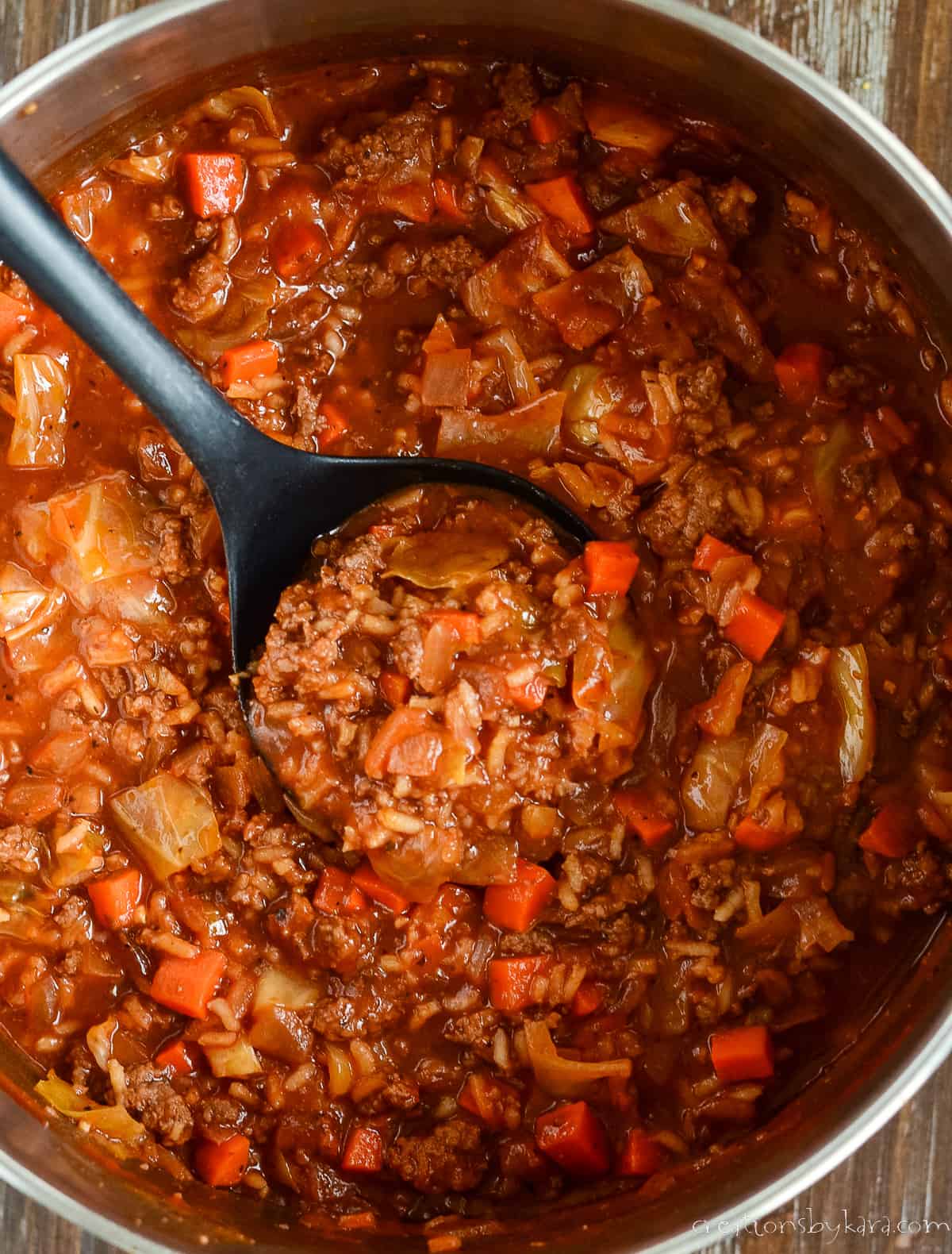 overhead shot of a pot of soup with a ladle