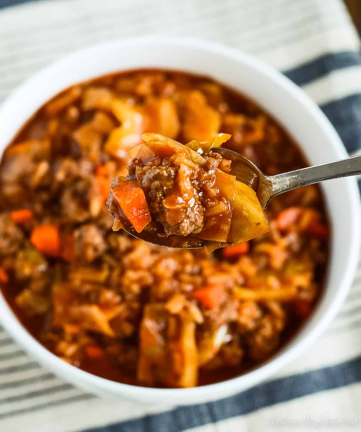 spoonful of stuffed cabbage soup over a bowl of soup