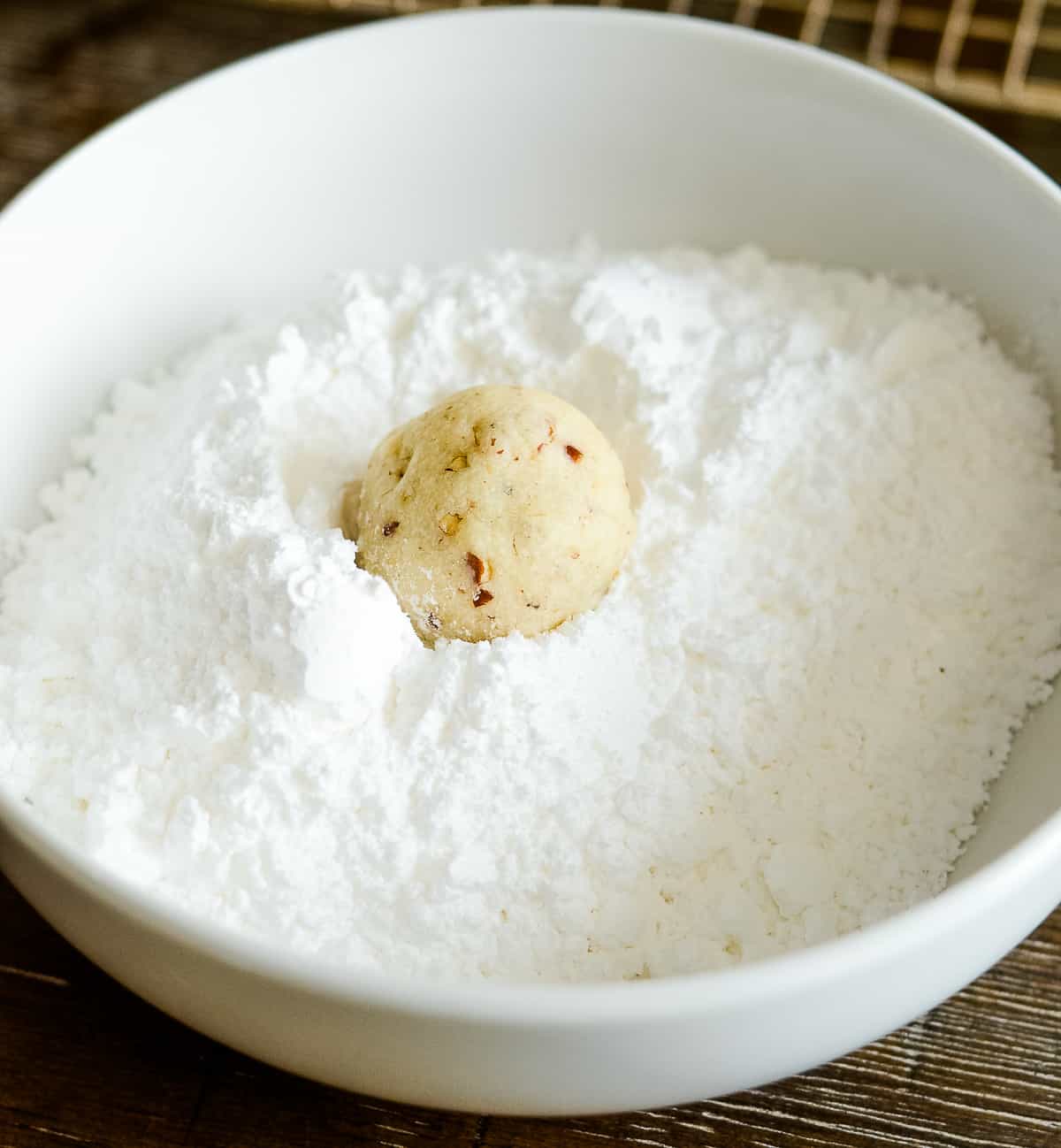 process shot - rolling cookie in powdered sugar