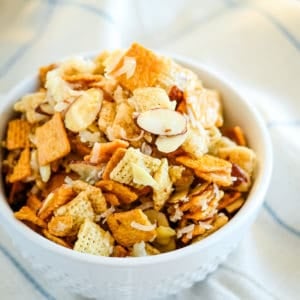 bowl of gooey chex mix with coconut and almonds