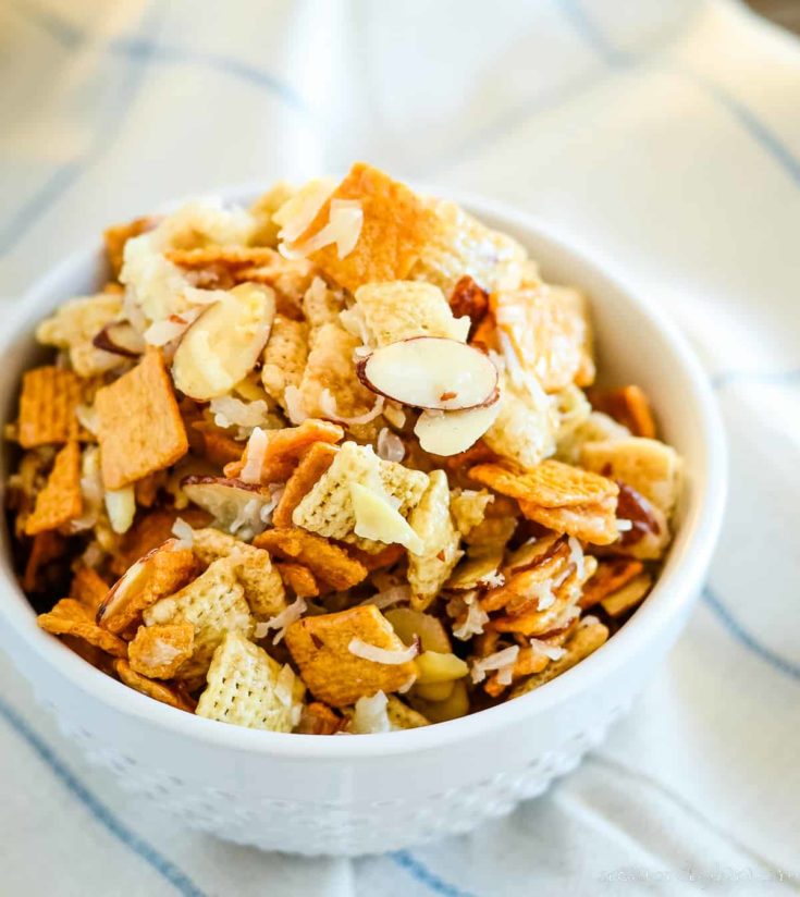 bowl of gooey chex mix with coconut and almonds