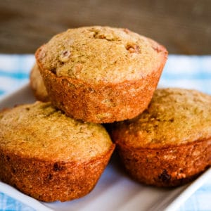 stack of bran muffins on a white plate