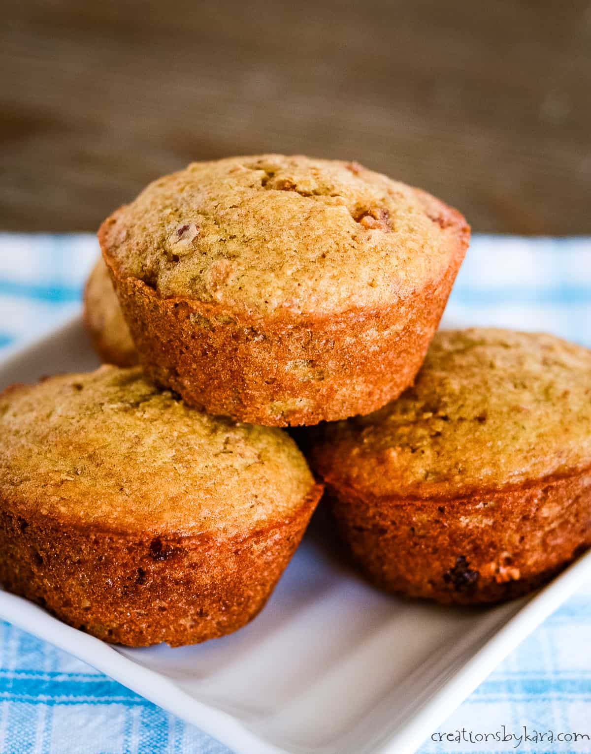 stack of bran muffins on a white plate