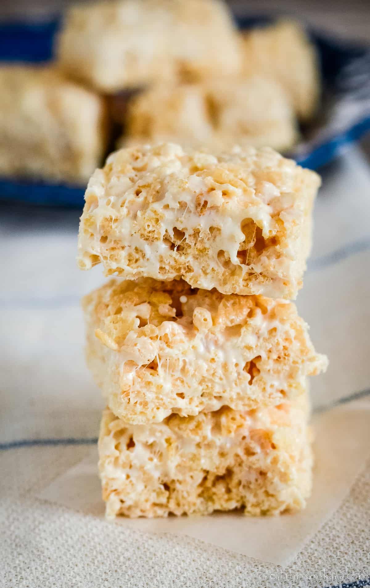 stack of brown butter rice krispie treats on waxed paper