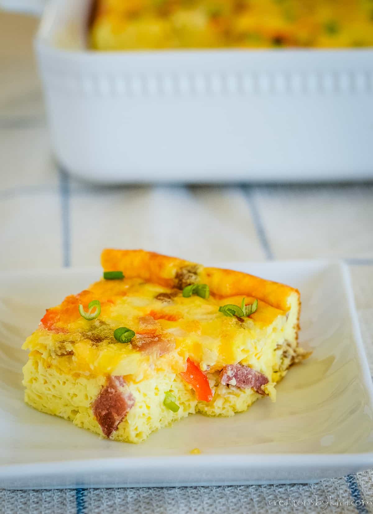 piece of easter breakfast casserole on a plate with a pan in the background