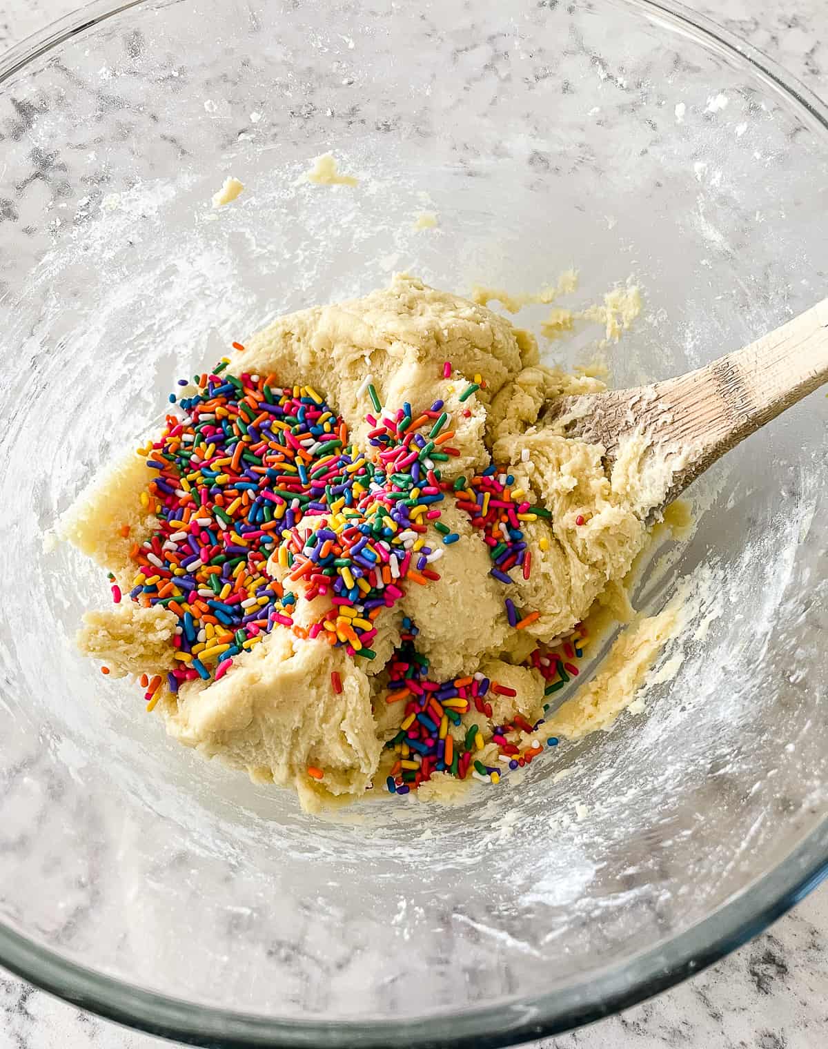 sprinkles being added to cookie dough